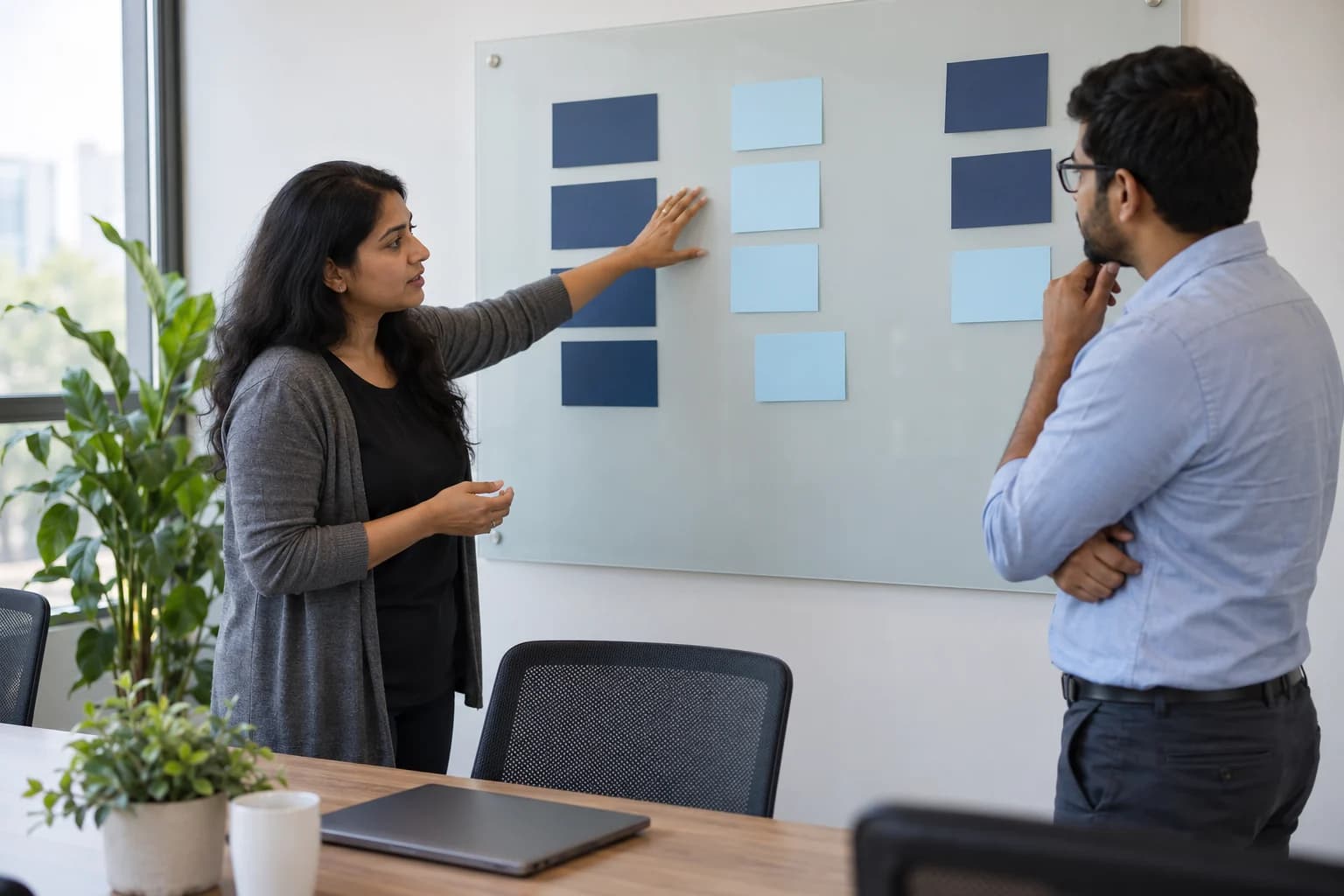 AI-generated editorial illustration of two technology-services colleagues reviewing blank planning cards; not Spruce InfoTech employees or a customer project.