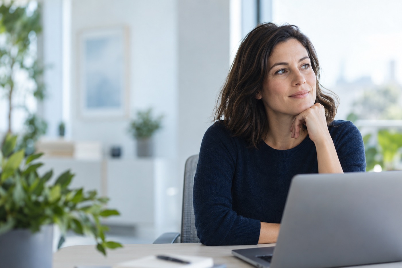 A thoughtful professional at work in a bright office