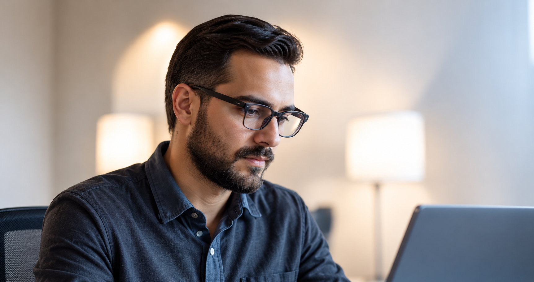 An operations professional reviewing work at a desk